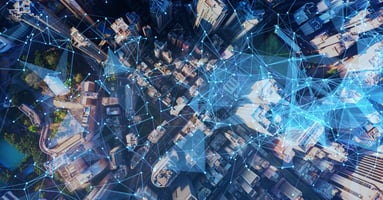 Aerial view of a city with a network overlaid it. 