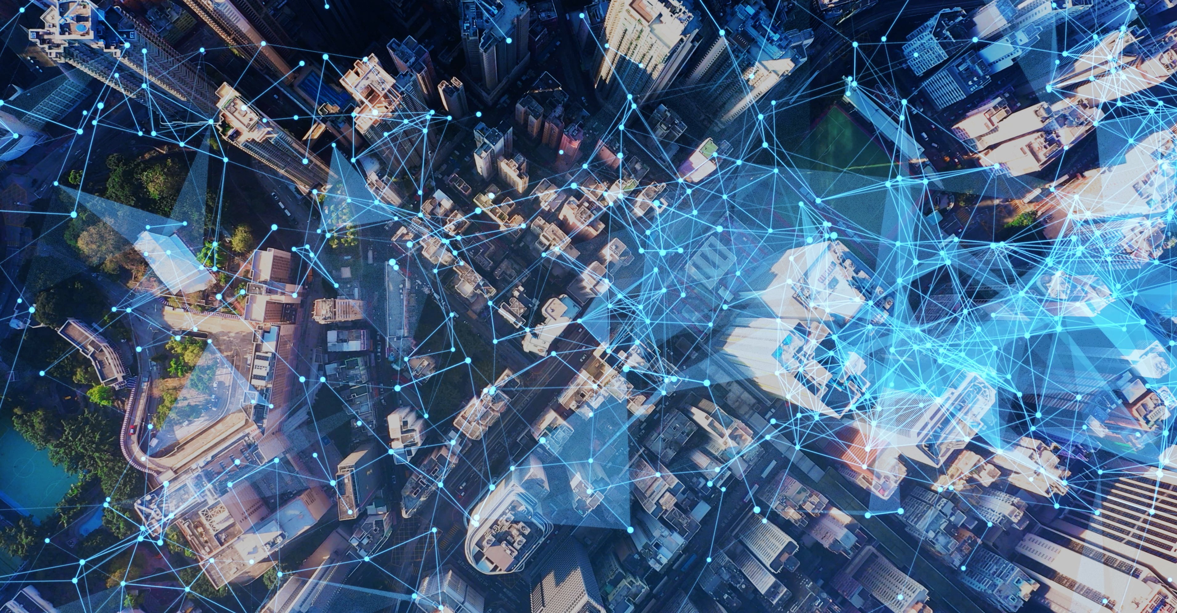 Aerial view of a city with a network overlaid it. 